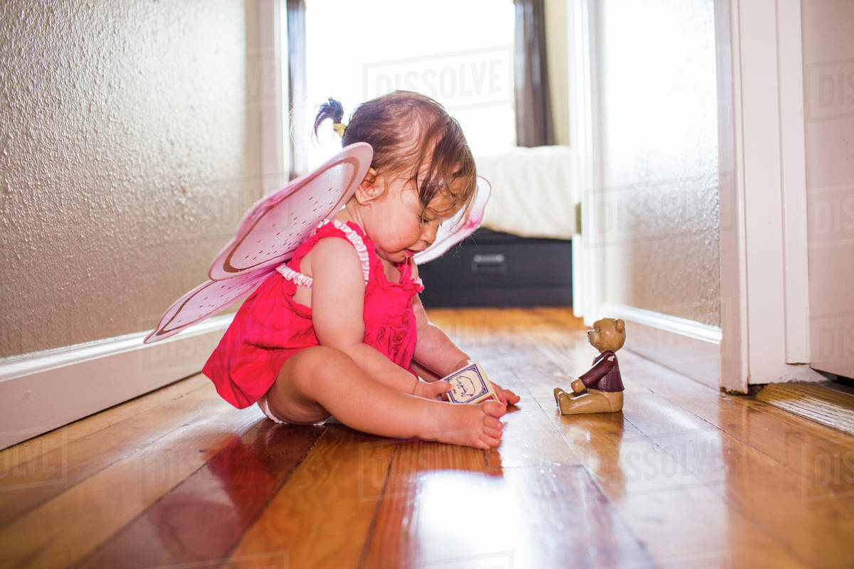 Caucasian baby girl playing in fairy wings Royalty-free stock photo