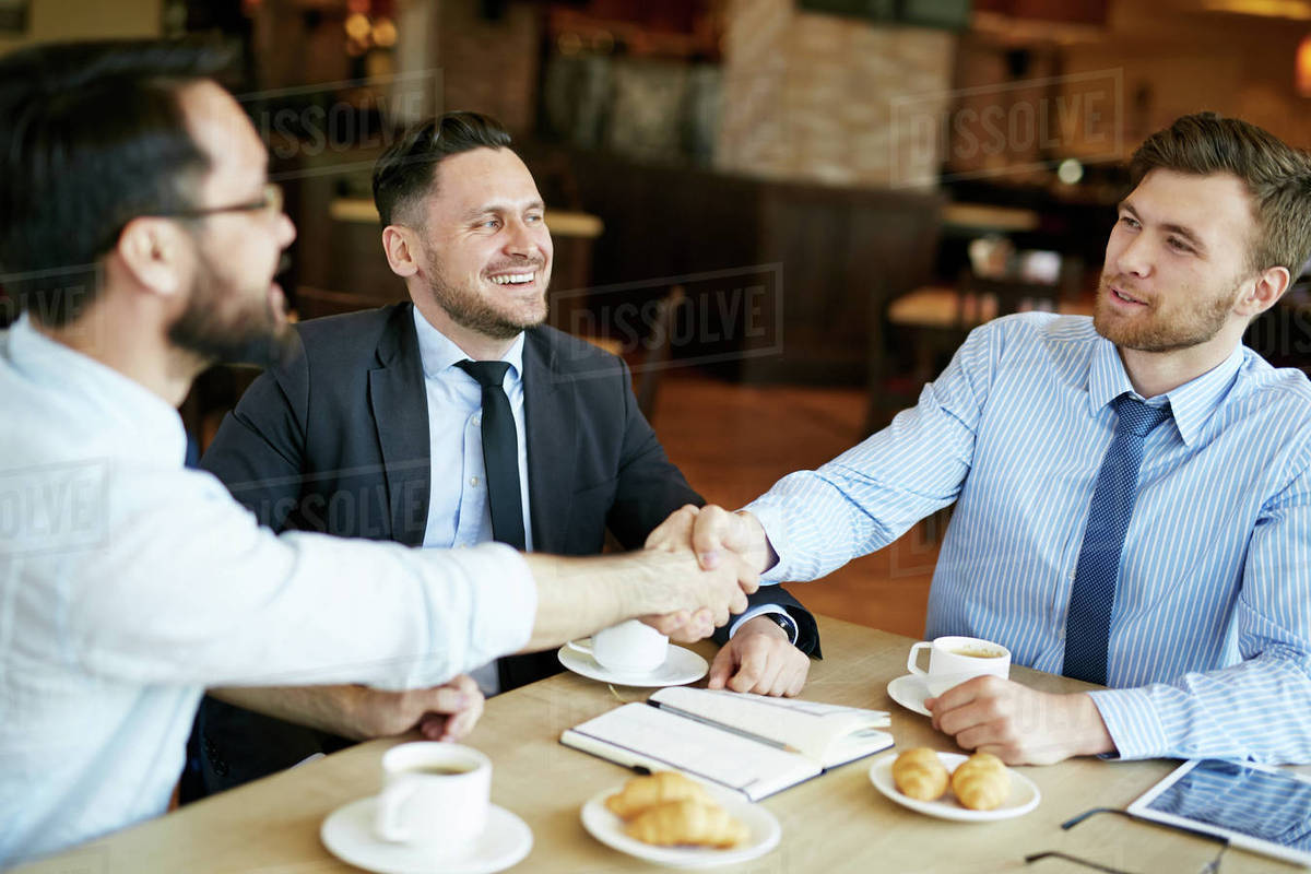 Two formally dressed pleased businessmen in shirts on casual meeting in