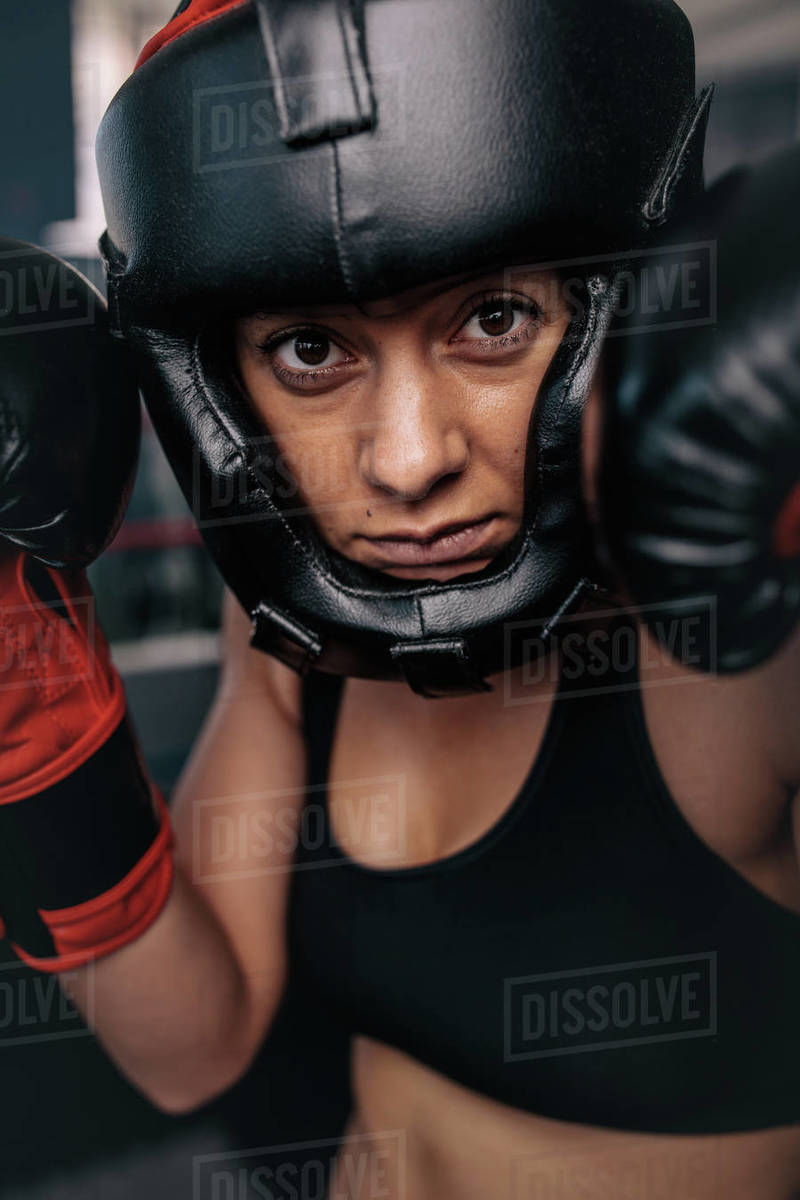 Close up portrait of a female boxer in her boxing gear. Woman boxer at