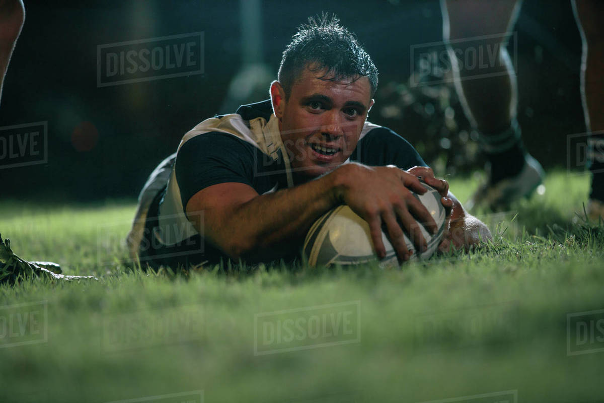 Rugby player scores a touchdown during the game. Rugby player making a