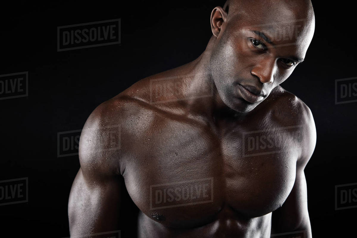 Closeup image of young man with muscular build. Shirtless african male