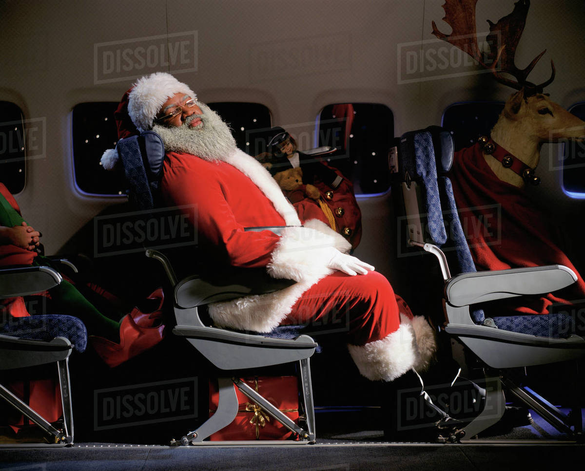 Santa Clause, reindeer and presents on an airplane Royalty-free stock photo