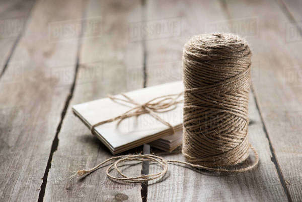 Selective focus of untangled beige string near wrapped letters on ...