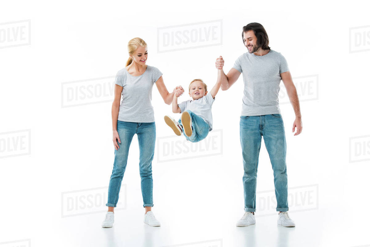 Parents throwing up their child while holding hands isolated on white Stock Photo Dissolve