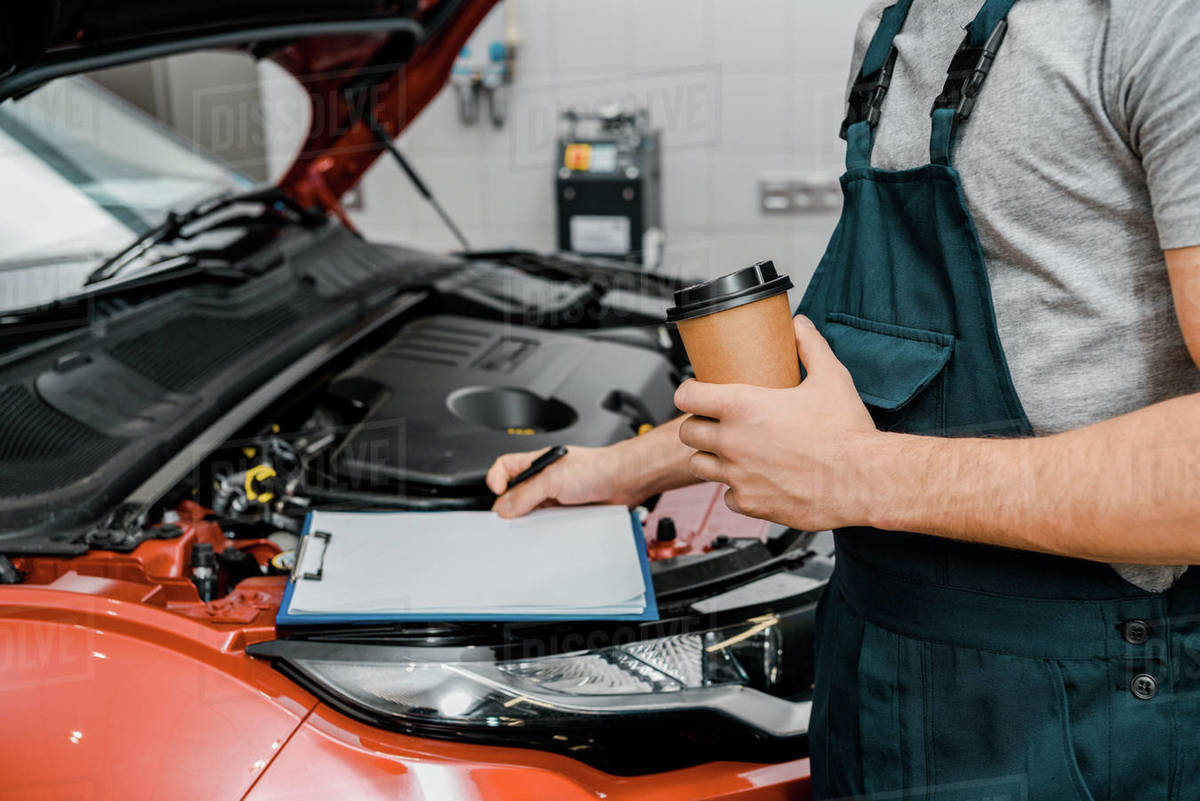 Auto Repair Nearby >> Partial View Of Male Auto Mechanic With Notepad And Coffee D2115 183 216 Auto Repair Nearby >> Partial View Of Male Auto Mechanic With Notepad And Coffee D2115 183 216