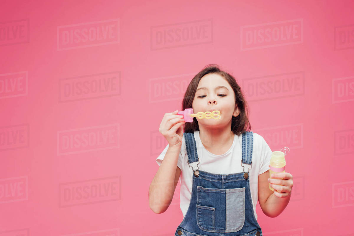 Funny kid blowing soap bubbles Stock Photo Dissolve