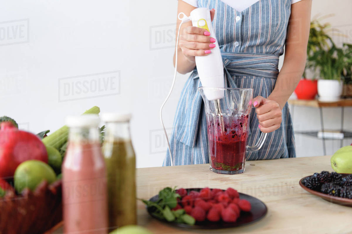 woman cooking homemade detox drink