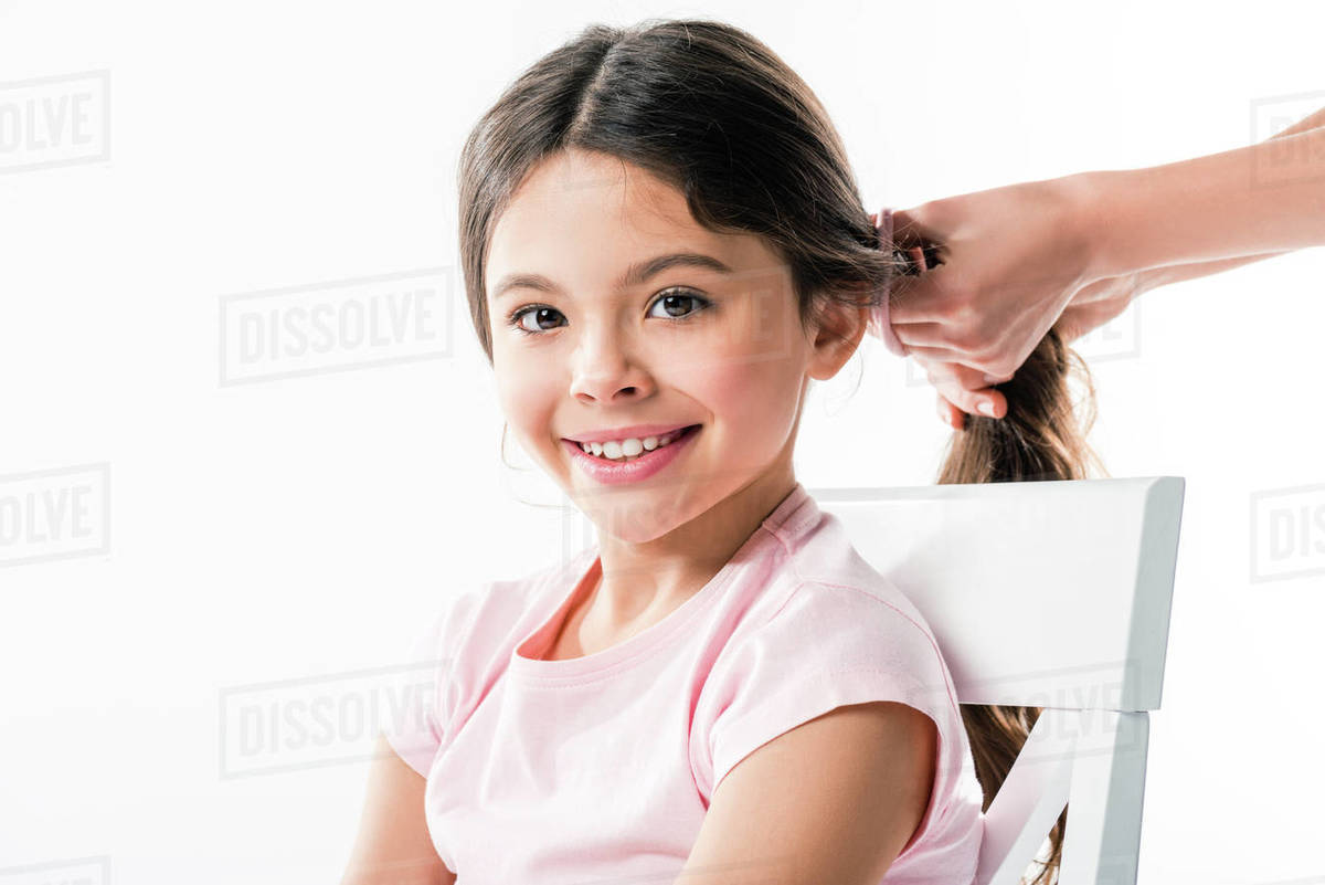 cropped-image-of-mother-tying-daughters-long-hair-in-ponytail-isolated