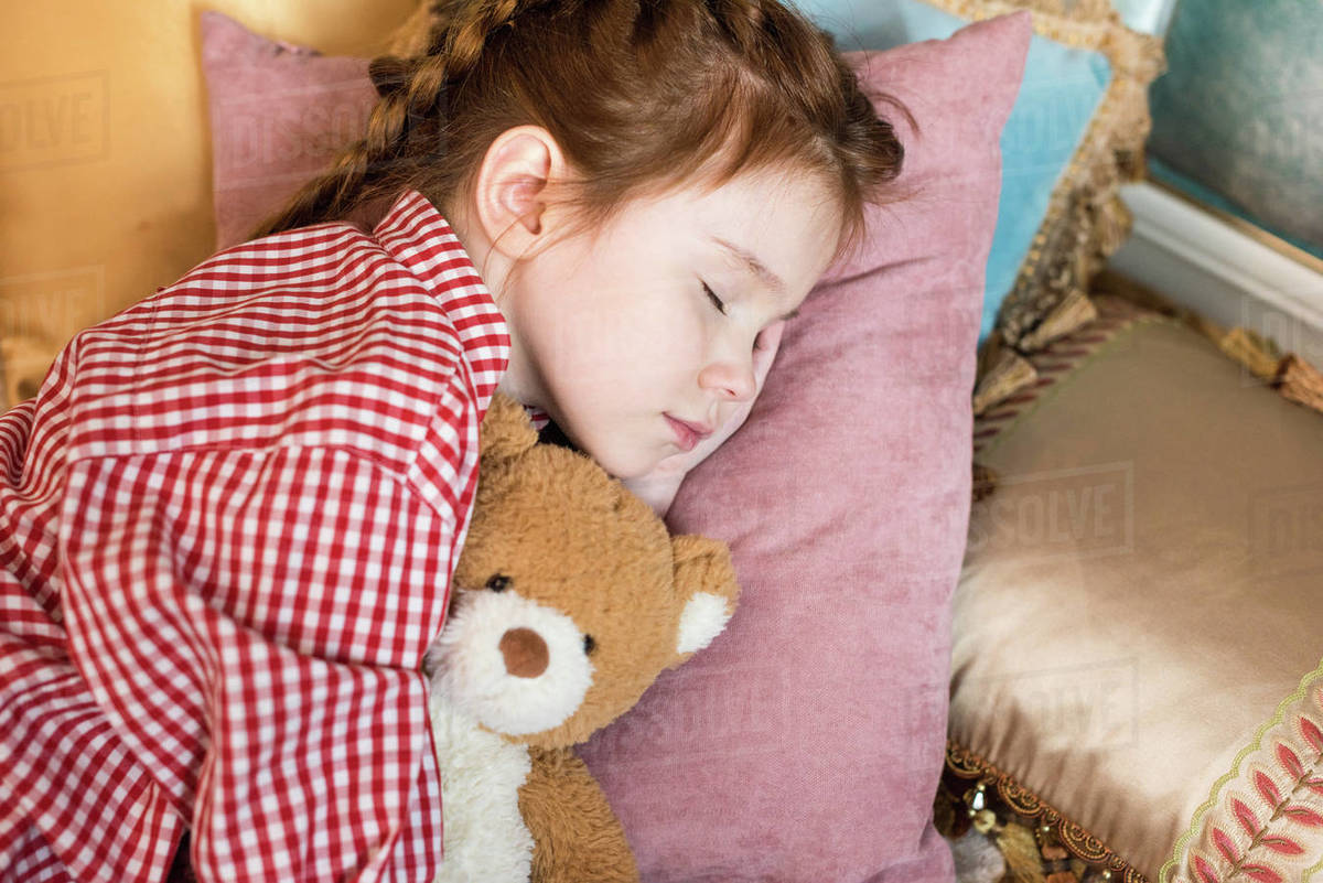 Adorable little child sleeping with teddy bear Stock Photo Dissolve