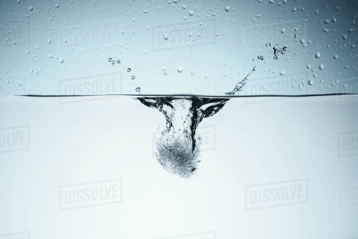 Ice cube in water with drops, isolated on white - Royalty-free Stock ...