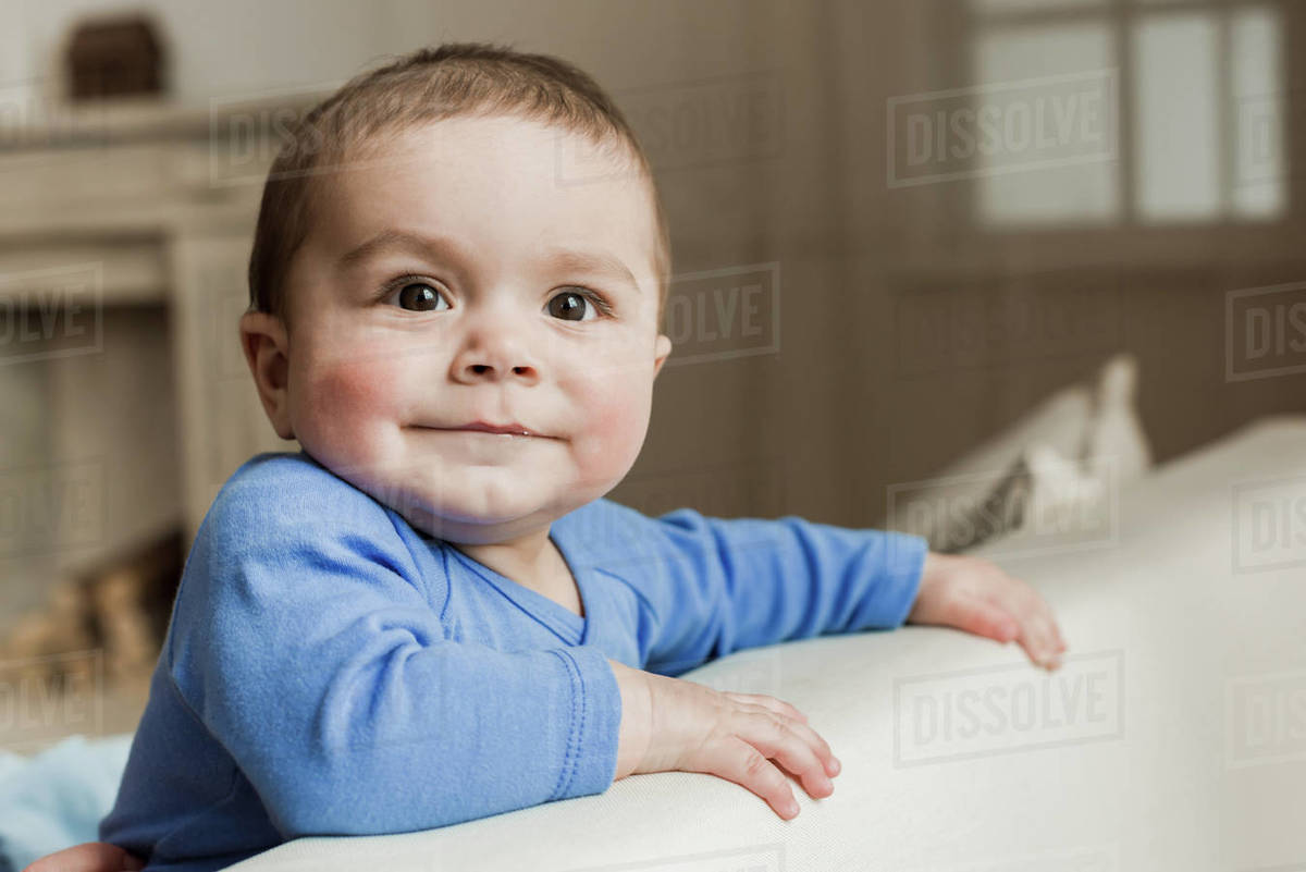 Portrait of funny baby boy looking at camera with smile Stock Photo