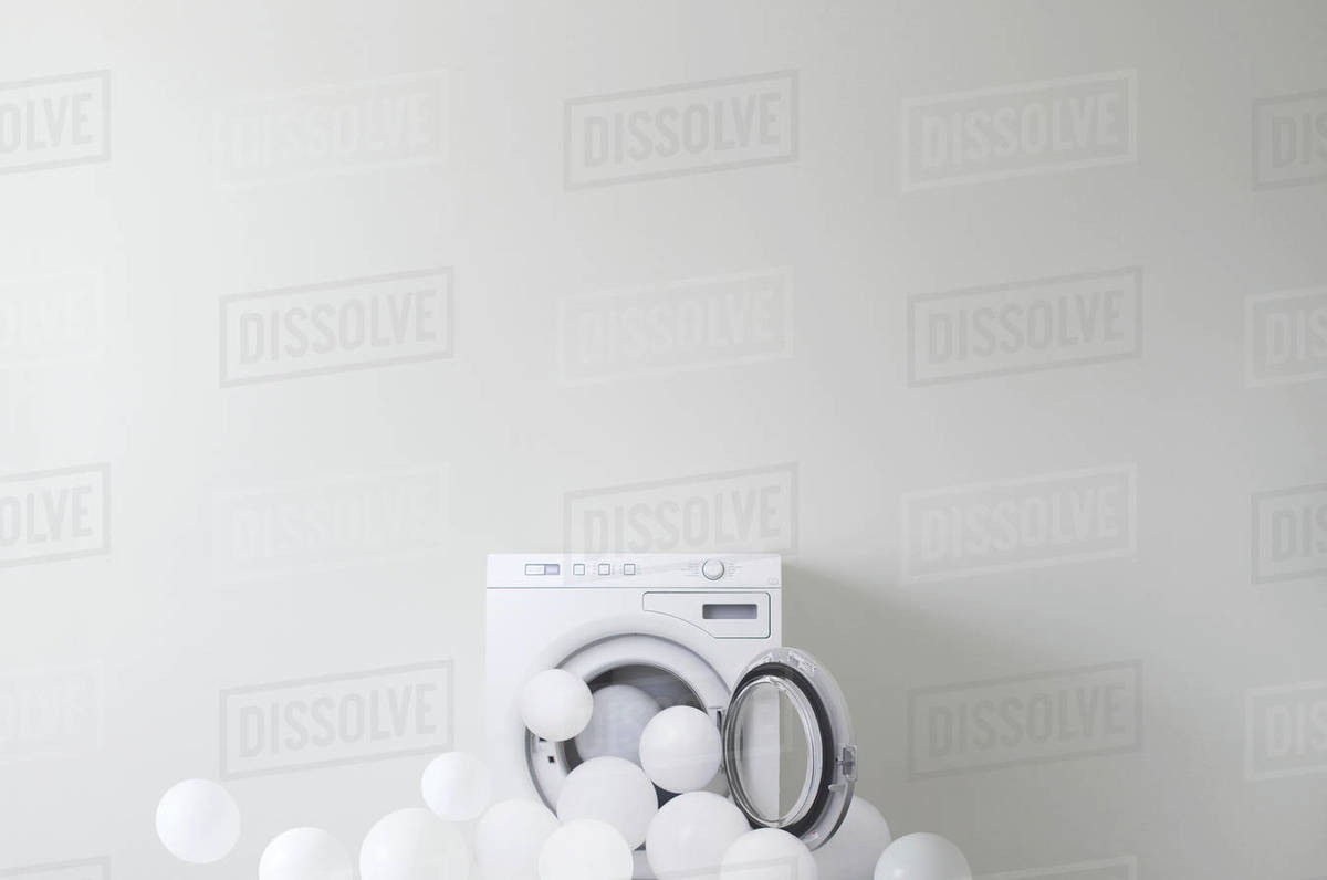 Conceptual washing machine leaking soap suds Stock Photo Dissolve