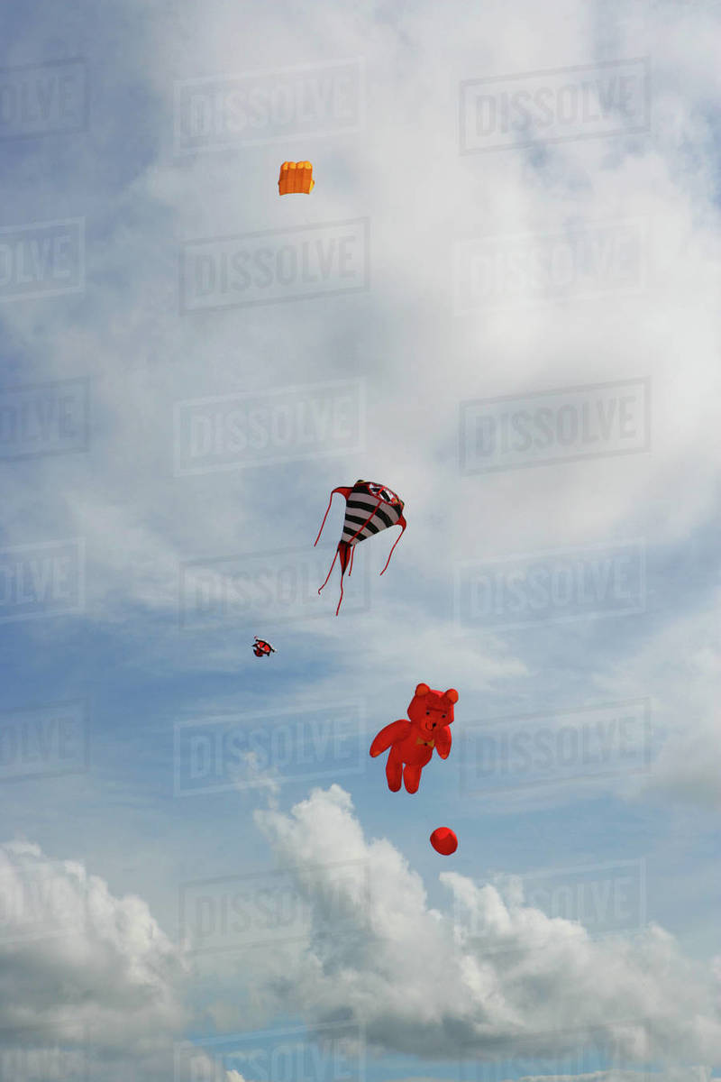 Kites flying in sky Stock Photo Dissolve
