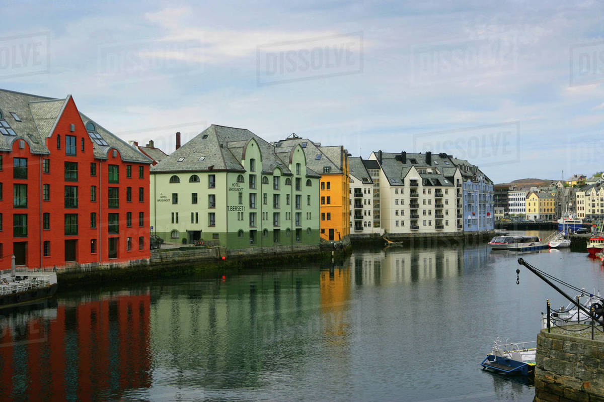 Norway, Alesund, Houses next to canal Stock Photo Dissolve