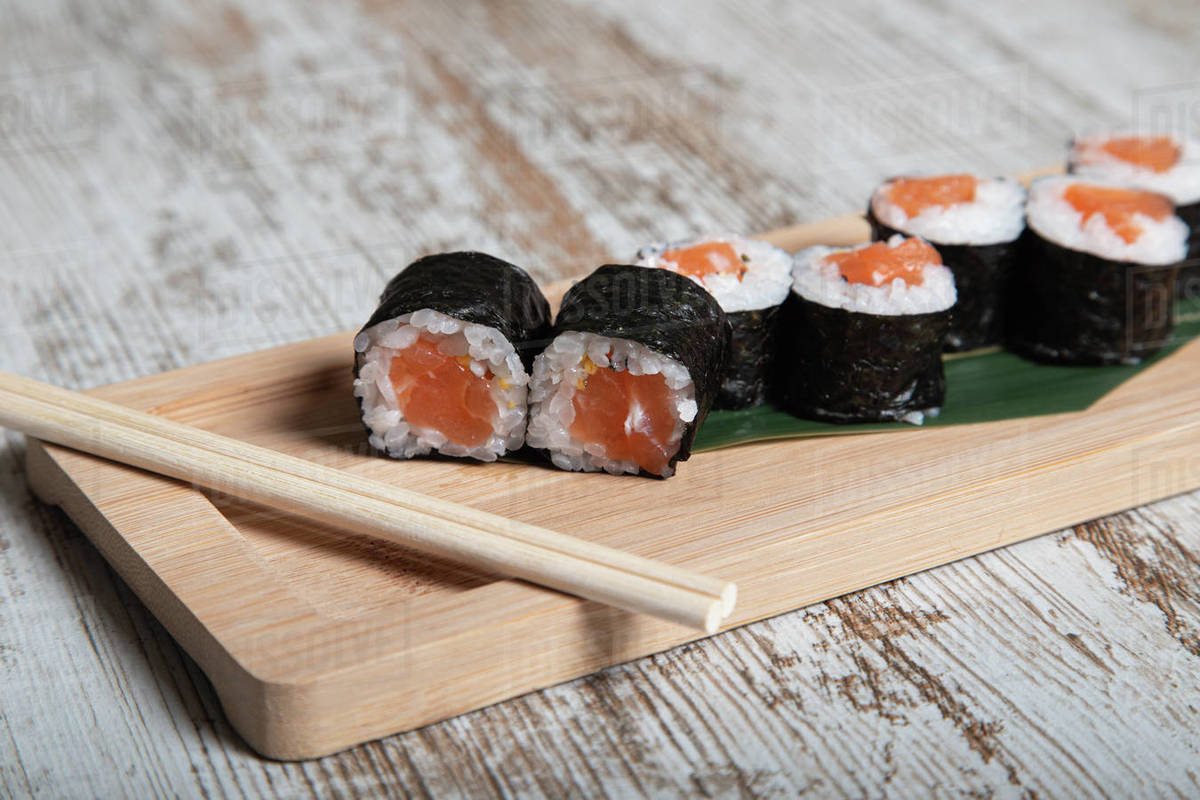 Set of Japanese hosomaki sushi rolls with fresh salmon fillet served on