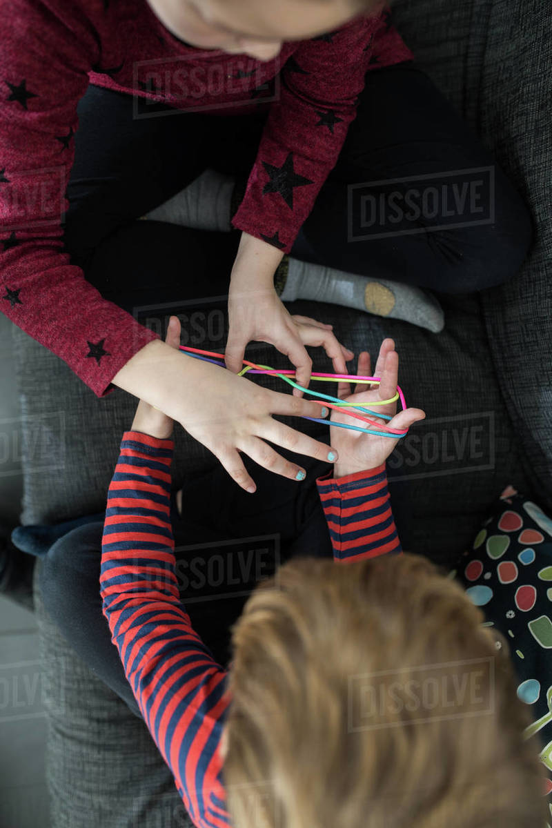 Smart children using rubber bands for game Stock Photo Dissolve
