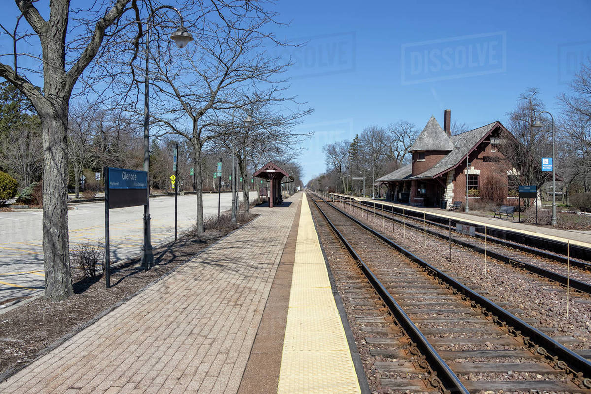 A suburban train station commuter parking lot and platform which would