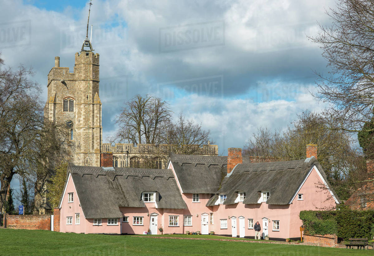 The village green in Cavendish with the medieval St. Mary church tower and traditional pink thatched cottages, Cavendish, Suffolk, England, United Kingdom, Europe Royalty-free stock photo