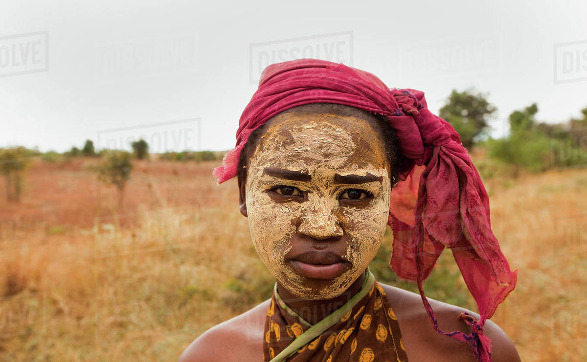 Portrait of young woman wearing dry mud, used to preserve the skin and