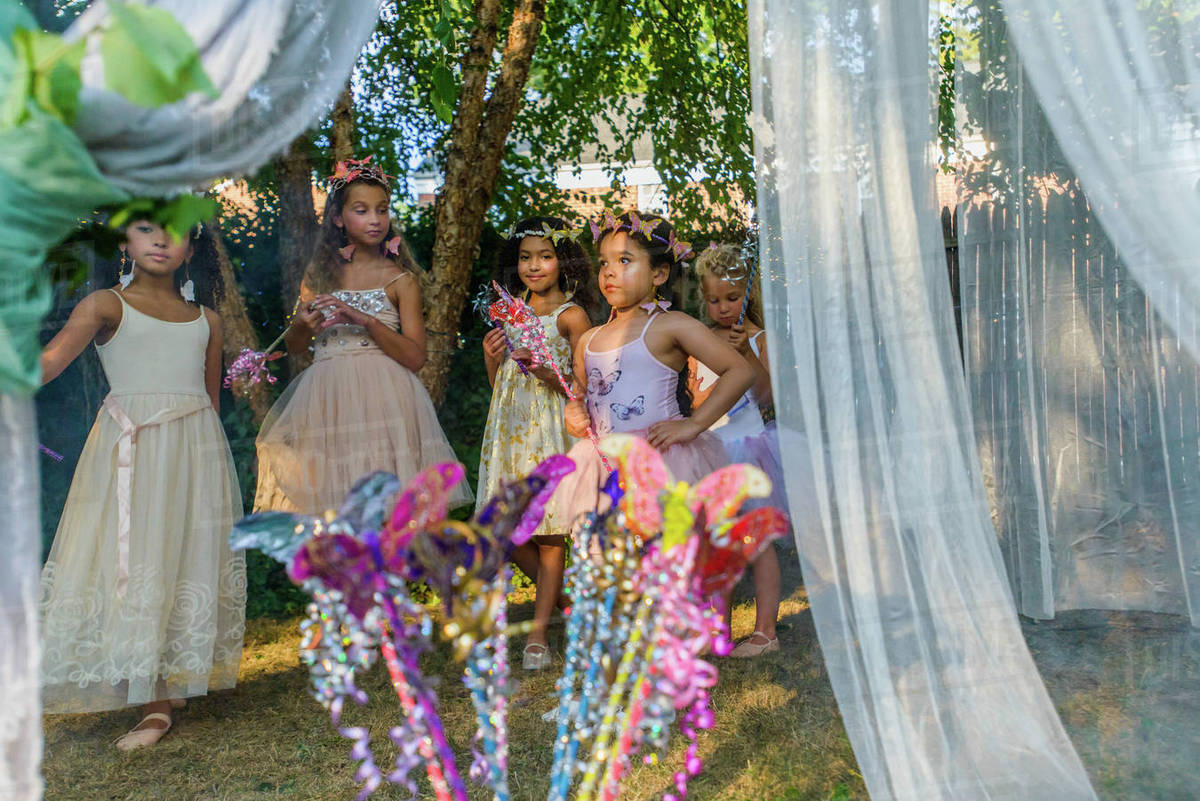 Group of young girls dressed as fairies, playing outdoors Royalty-free stock photo