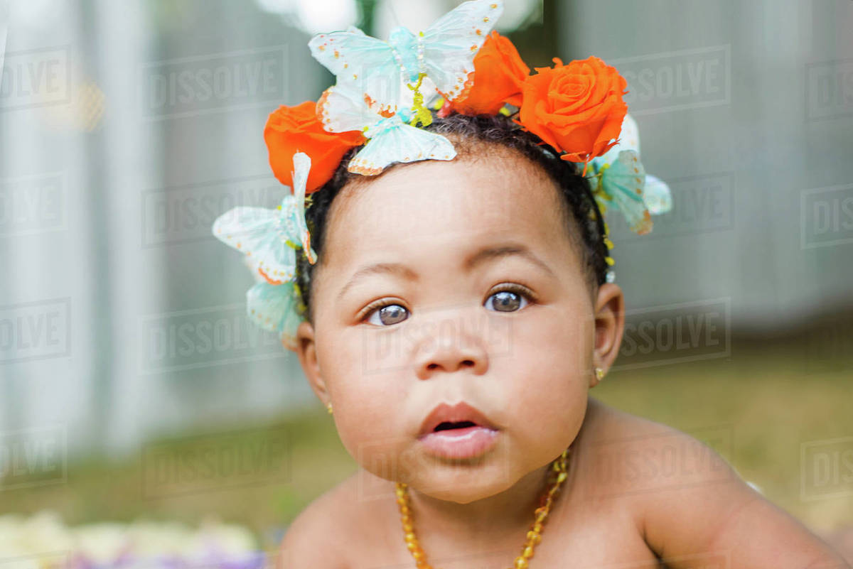 Portrait of baby girl wearing butterflies and flowers in her hair Royalty-free stock photo