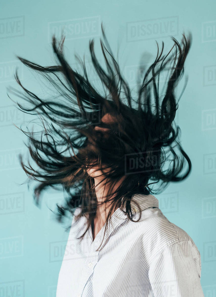 Young Woman With Long Hair Tossing Head Back Stock Photo Dissolve