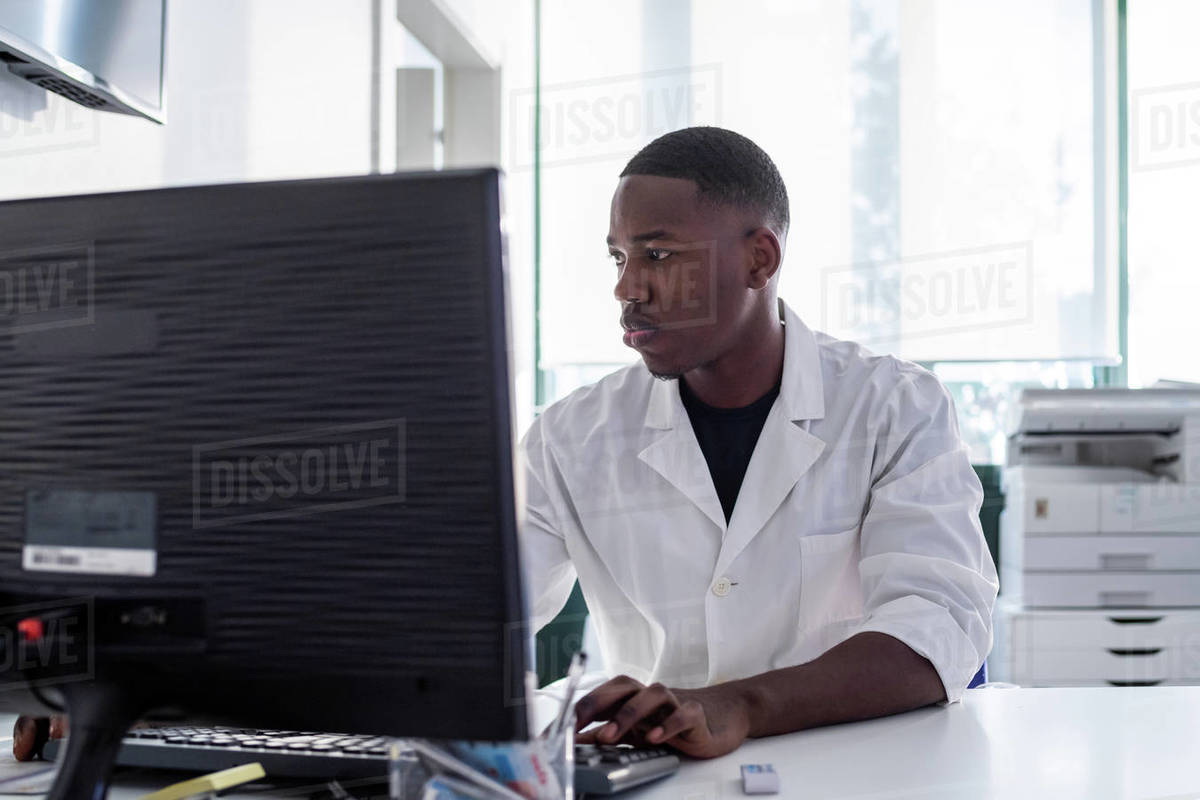Doctor working on computer in hospital Stock Photo Dissolve
