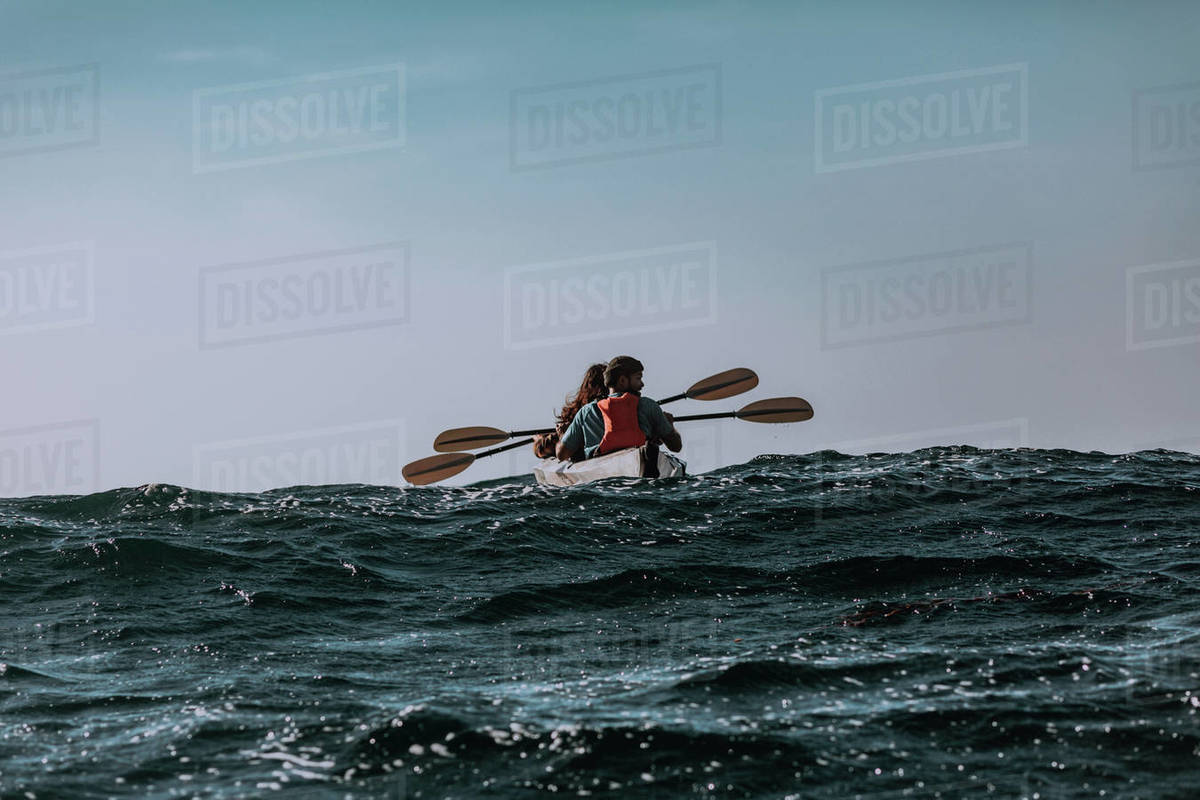 Friends kayaking in sea, Big Sur, California, United States - Stock