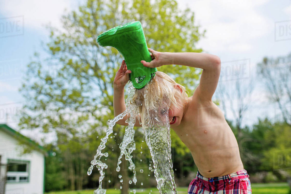 Canada, Kingston, Shirtless boy (89) pouring water from rubber boot on