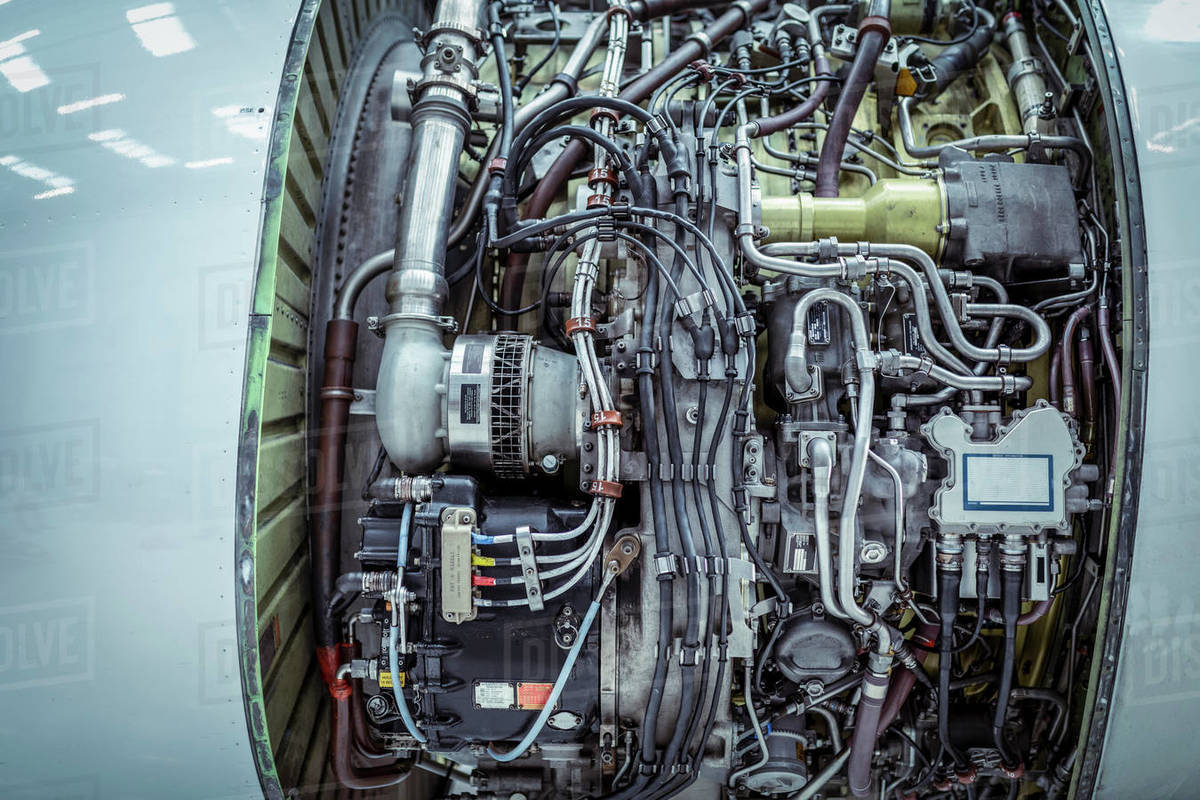 Closeup of internal parts of jet engine in aircraft maintenance hangar