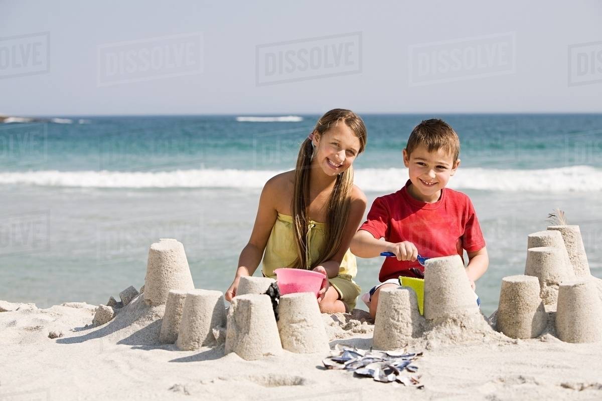 And Boy Making Sandcastles On The Beach Stock Photo Dissolve And Boy Making Sandcastles On The Beach
