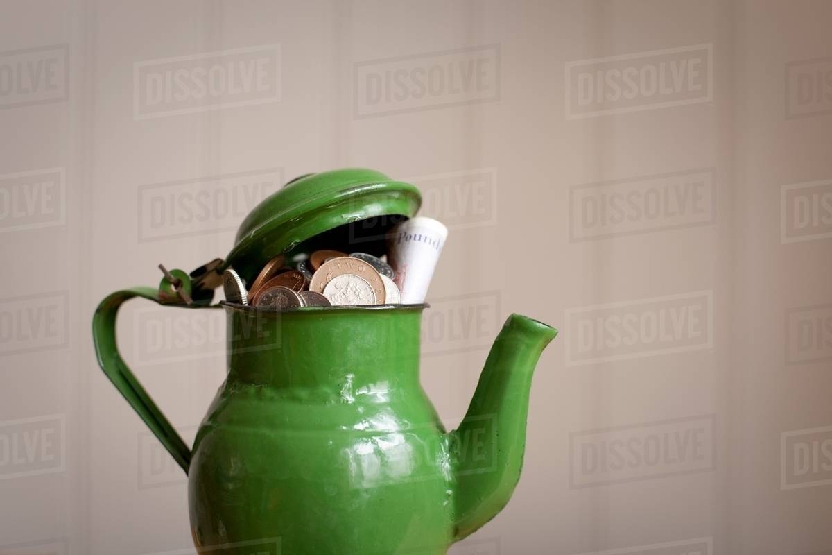 Money in a teapot Stock Photo Dissolve