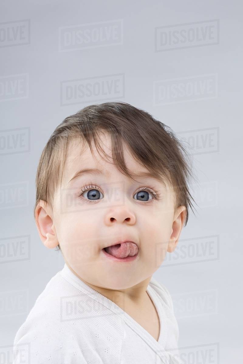 Baby sticking out tongue Stock Photo Dissolve