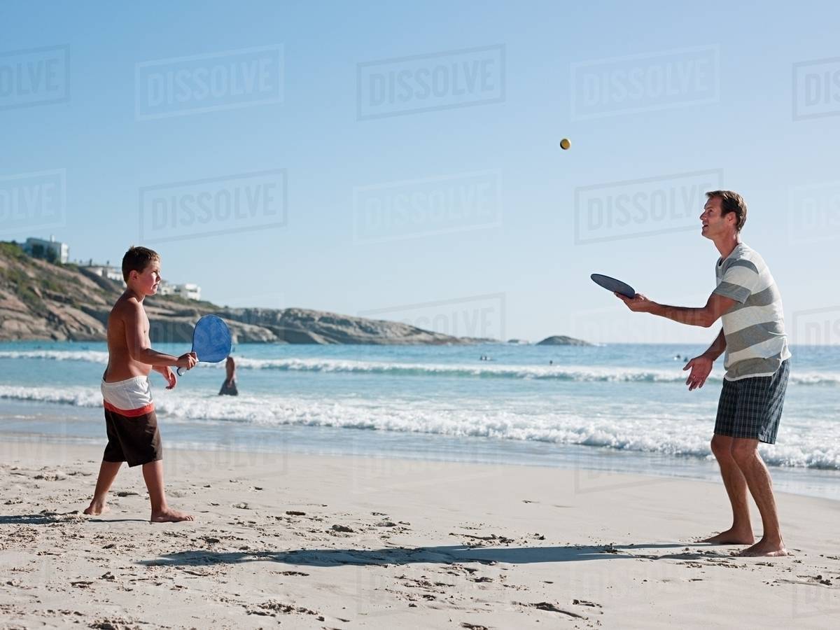 Father And Son On Playing Paddleball Beach Stock Photo Dissolve Father And Son On Playing Paddleball Beach