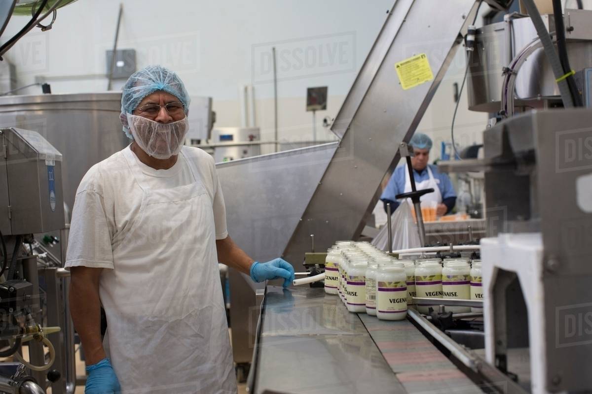 Man working in food production factory Stock Photo Dissolve