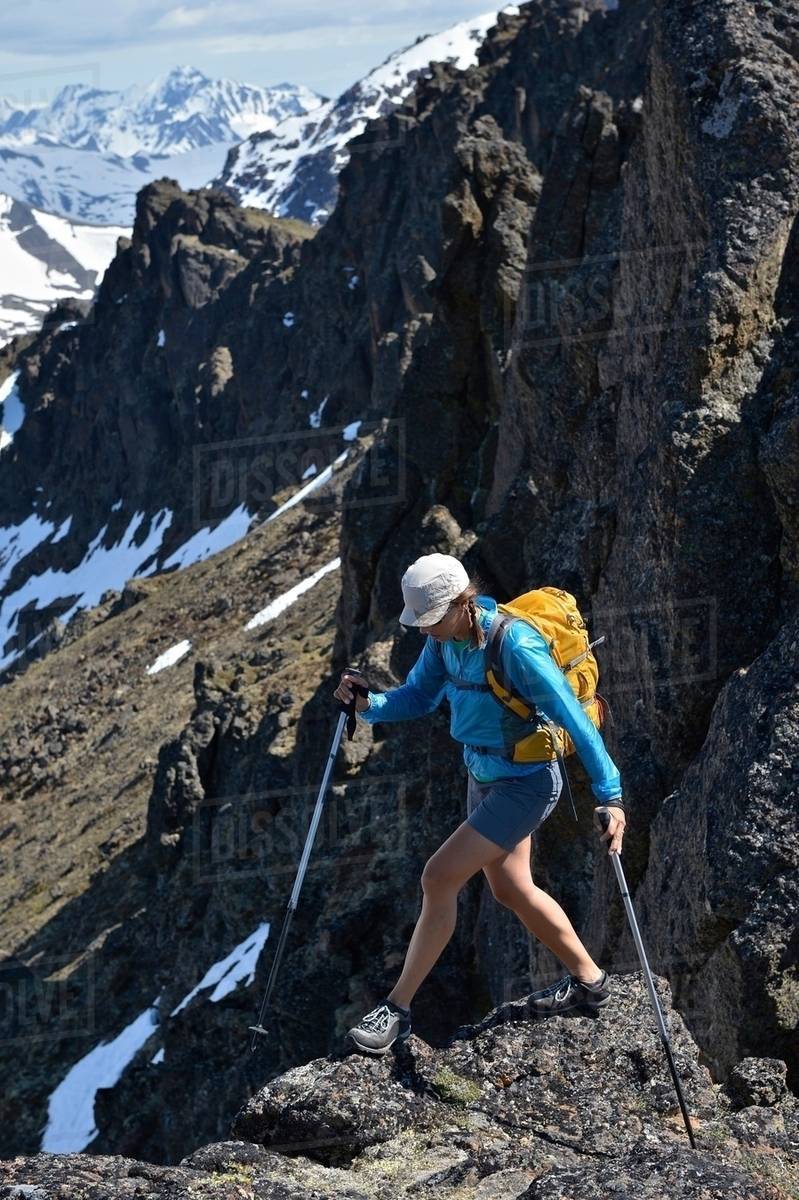 Female mountain climber on mountain edge, Chugach State Park, Anchorage ...