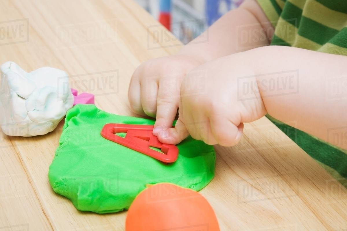 Child with modelling clay Stock Photo Dissolve