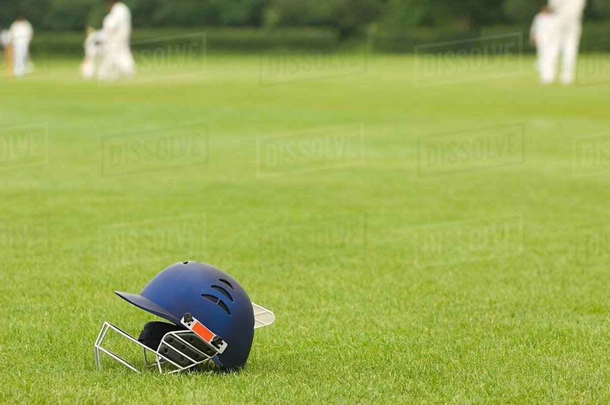 Cricket helmet on a cricket ground Stock Photo Dissolve