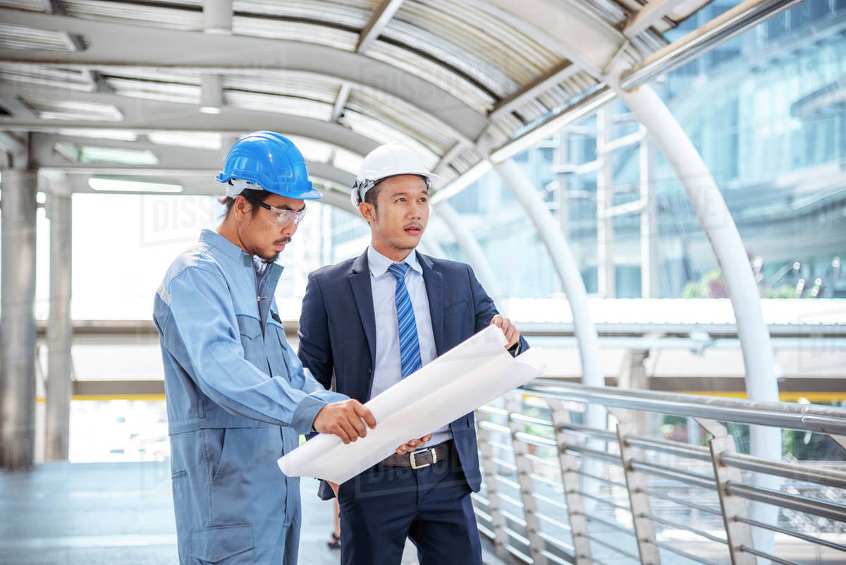 Construction engineer in Safety Suit Trust Team Holding White Yellow ...