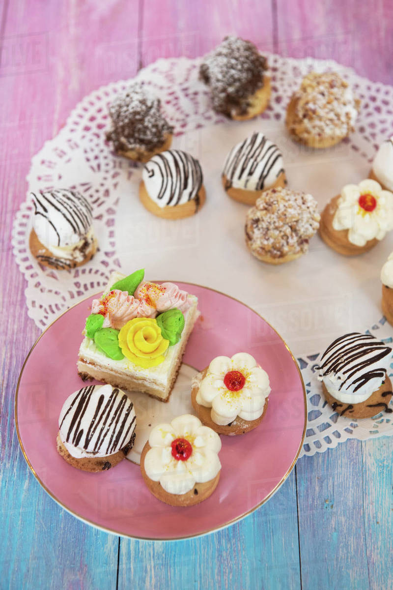 Different cakes composition on gradient background Stock Photo Dissolve
