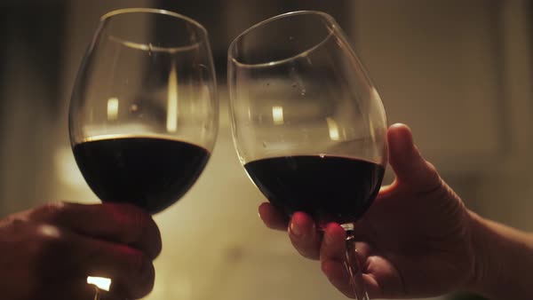 Romantic date dinner, couple drinking wine making cheers with