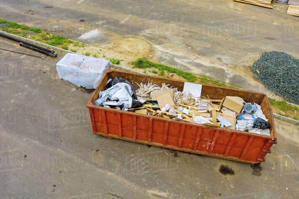 Construction trash garbage dumpsters on metal container house ...