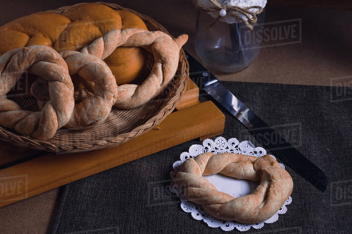 bread with thread on the table ready to cut with the knife Stock Photo Dissolve