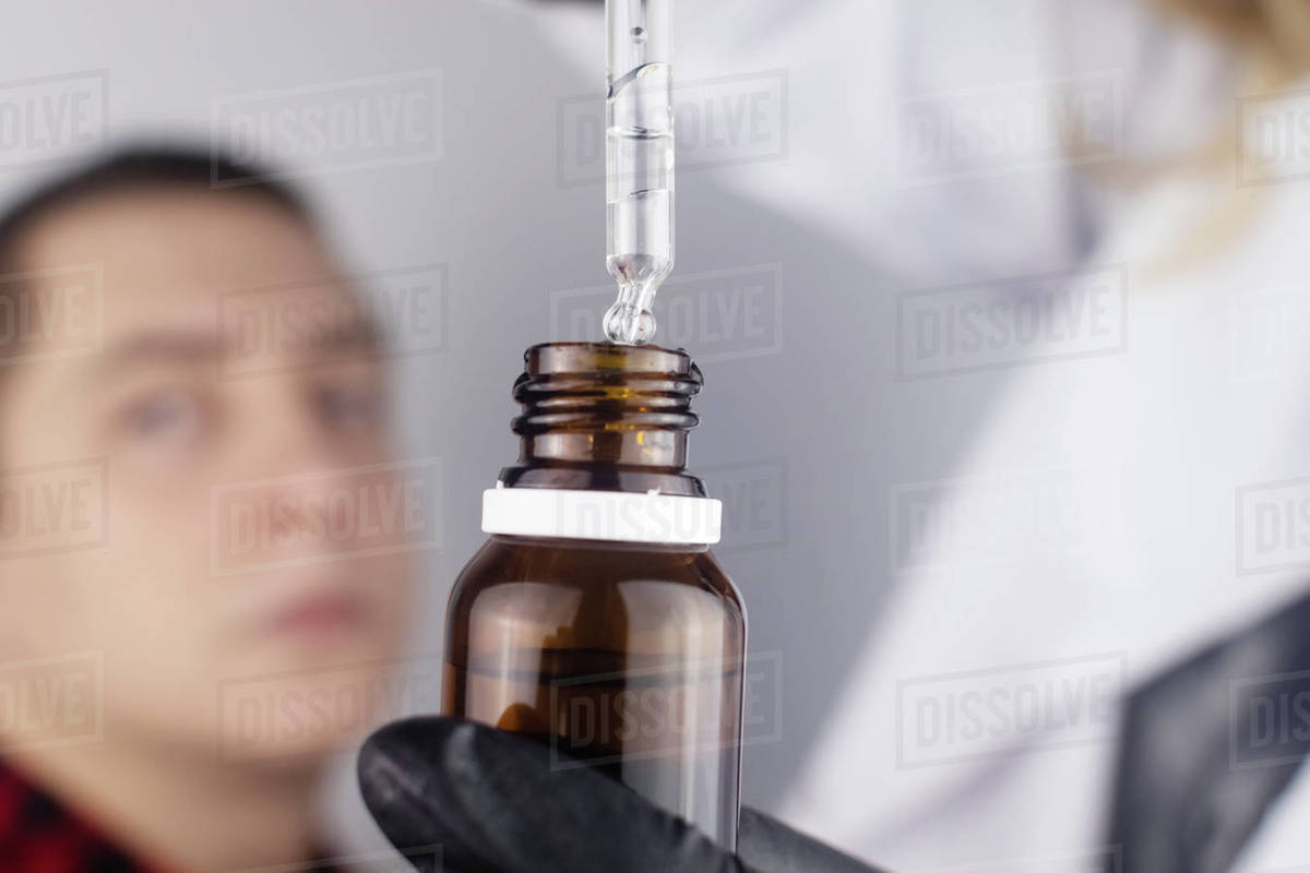 Closeup of eye drops. Doctor uses a pipette to apply eye drops