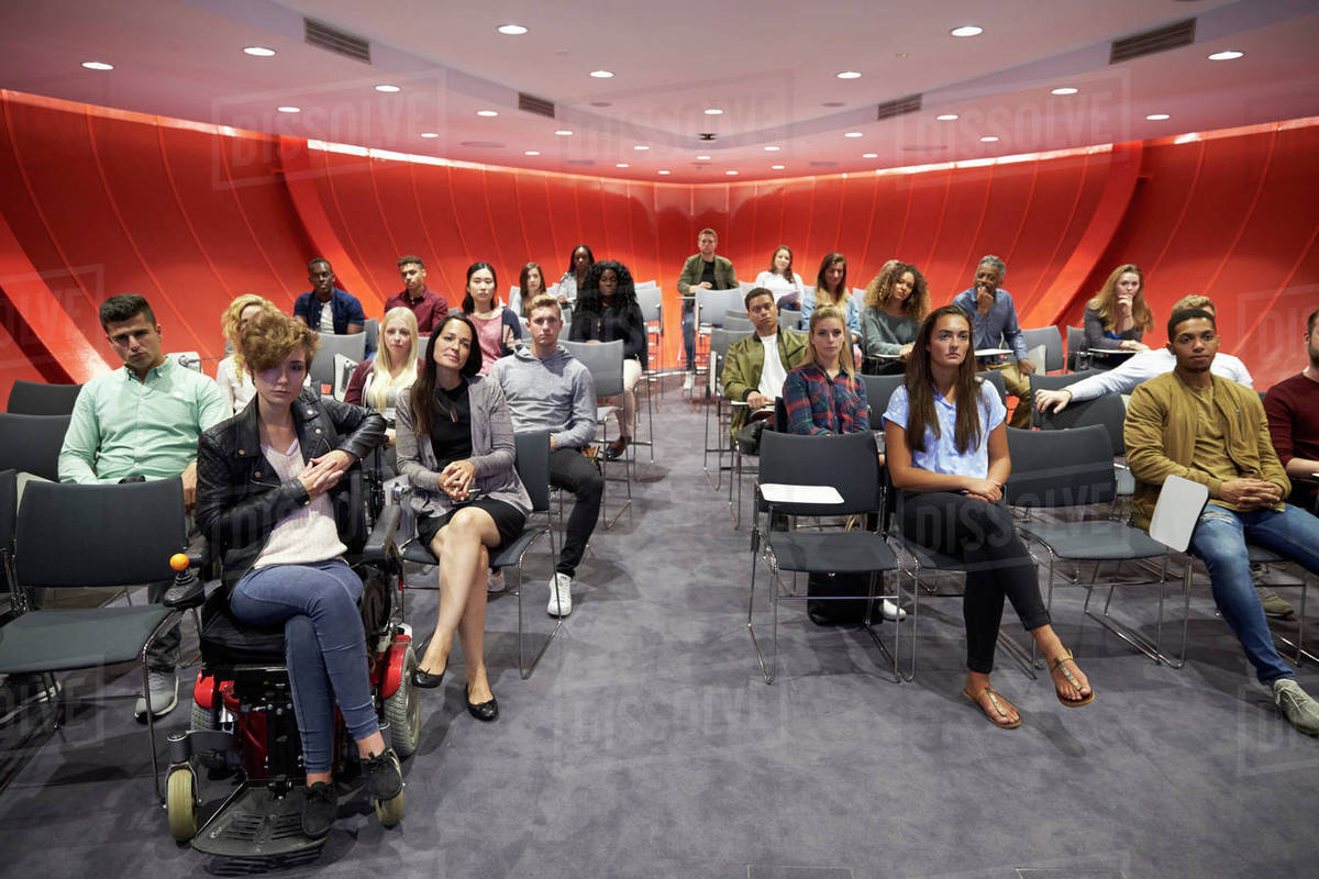 Students sit facing camera in a modern university classroom - Royalty ...