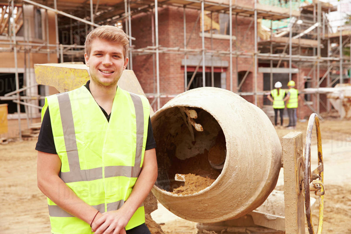 Portrait of worker on building site mixing cement Stock Photo Dissolve