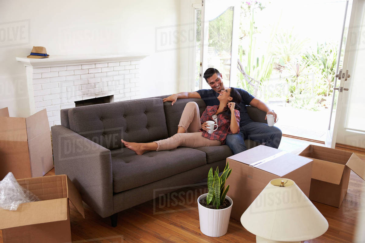 On Sofa Taking A Break From Unng Moving Day Stock Photo