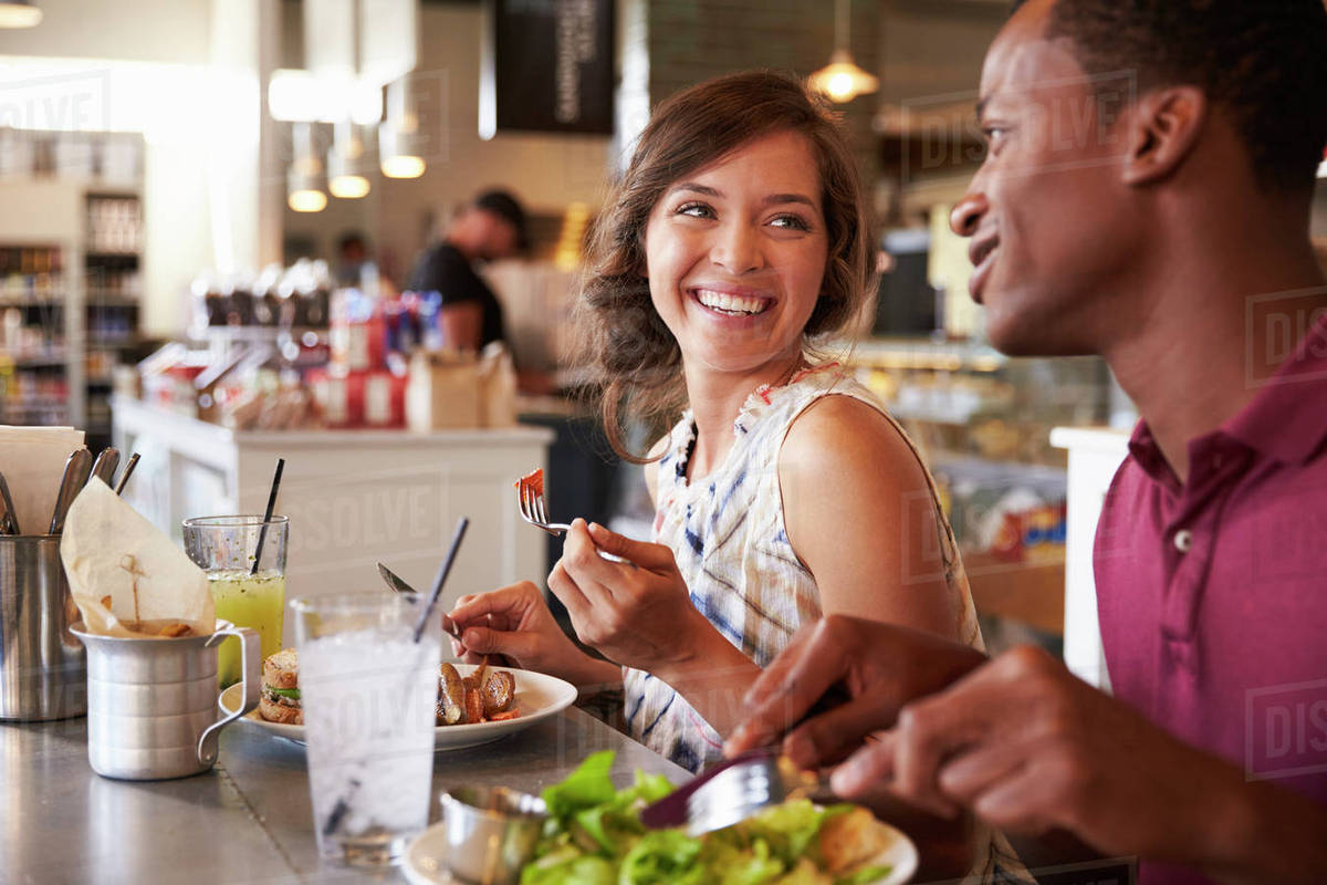 couple enjoying lunch date in delicatessen restaurant stock photo