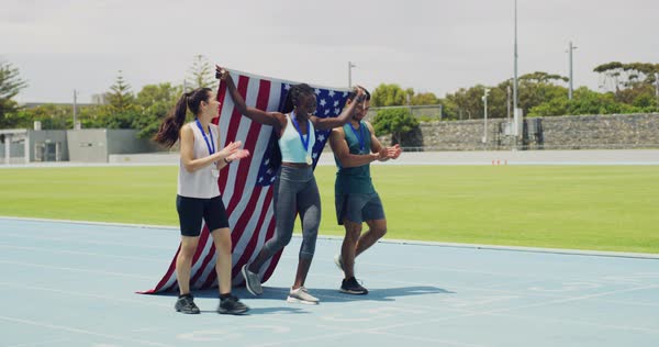Team of patriotic olympic athletes celebrating victory, walking and ...