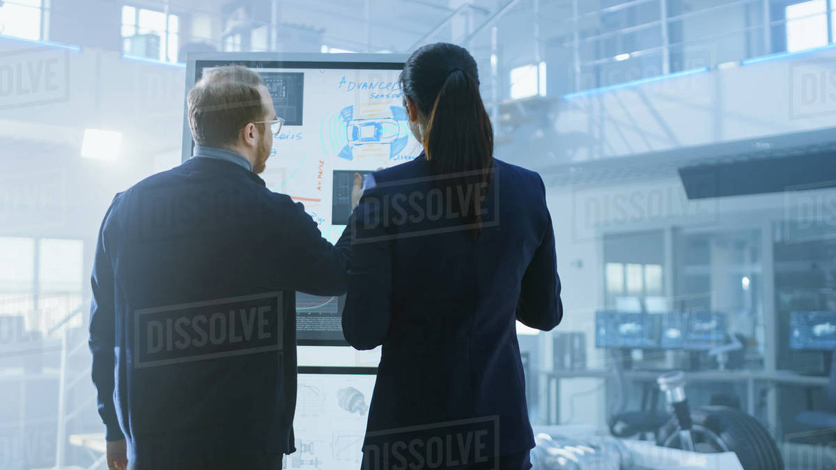 Male and Female Design Engineers are Working and Discuss Electric Car